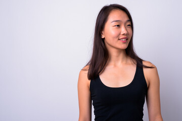 Portrait of happy young beautiful Asian woman