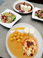 Chicken breasts with tomato and mozzarella with sauce on plate