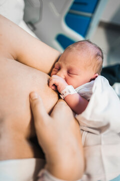 Mother breastfeeding one day newborn