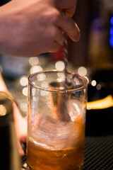 Barman's hand preparing a cocktail