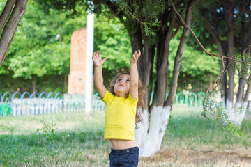 happy little boy playing in the park, long hair boy in the park