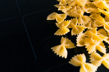 Pasta on modern ceramic plate in dark kitchen interior