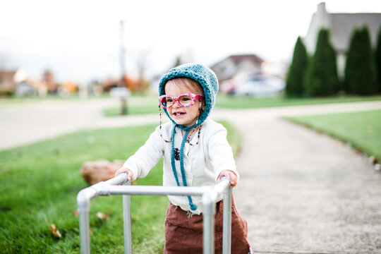 toddler girl dresses up as old lady with walker for Halloween