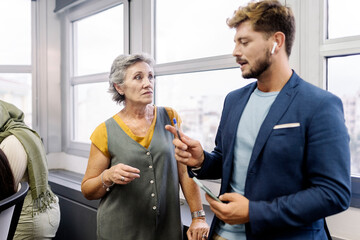 multinational team concept. muslim woman in hijab and caucasian senior woman working together