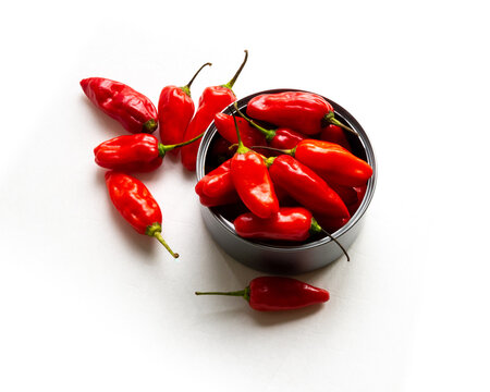 Red Sweet Peppers Stuffed In A Metal Can On A White Background