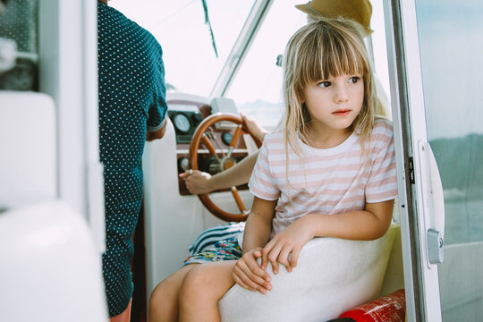 Little Girl Sitting In A Boat With A Woman