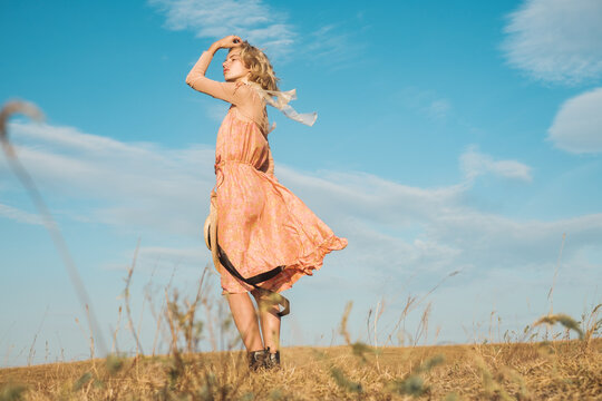 Stylish Blond Woman Wearing Pink Silk Dress Outdoors
