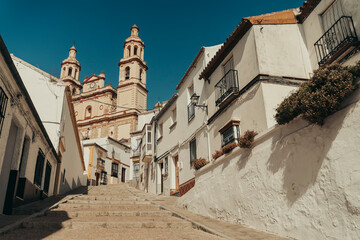 Old white town with church centered on the road.