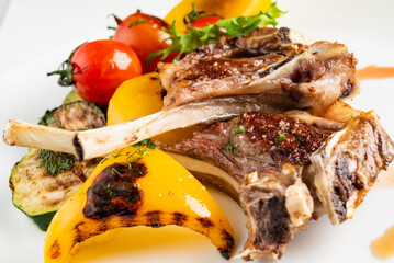 Modern French cuisine: Roasted Lamb neck & rack served with carrot, yellow curry and lamb sauce.