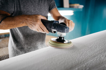 Anonymous shaper making a surfboard