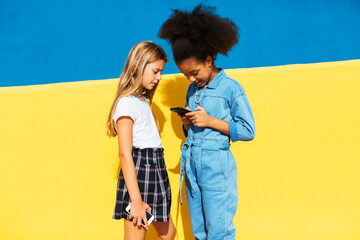 Diverse girls using smartphone together