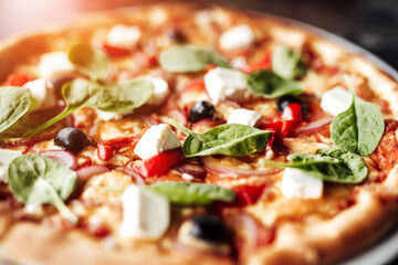 Delicious Italian food, homemade pizza with cheese, olives and herbs