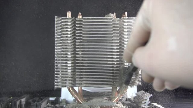 Dust pollution. Cleaning the processor radiator sink from dust. Antistatic brush. Slow motion.