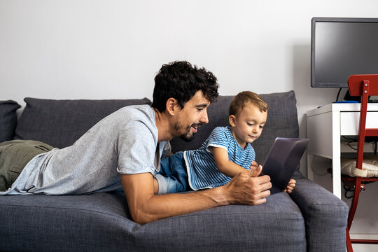 Happy father and his son using laptop