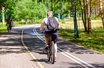Cyclist ride on the bike path in the city Park