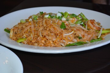 pad tai in a white plate with black background