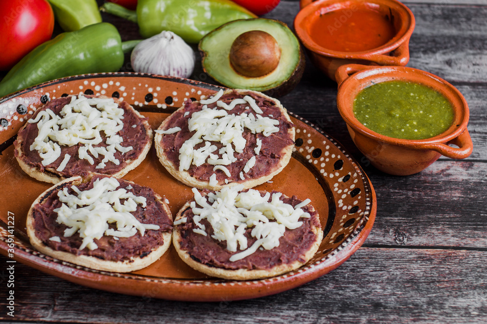 Wall mural Mexican sopes with grated cheese and fried beans, Traditional breakfast in Mexico