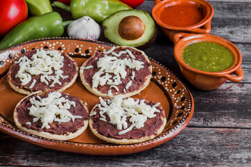 Mexican sopes with grated cheese and fried beans, Traditional breakfast in Mexico