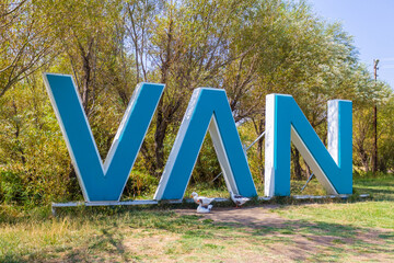 Van city, Eastern Turkey. The name of the town in big blue letters among trees and geese. City...