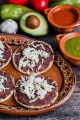 Mexican sopes with grated cheese and fried beans, Traditional breakfast in Mexico