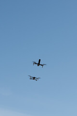 Two drones racing in the sky.