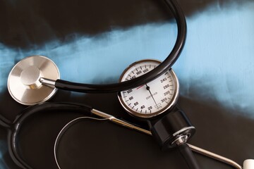 tonometer for measuring blood pressure on the blurred background of chest x-ray