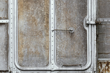 Locked door of old and rusty train wagon , damaged metal /grunge texture with scratches and cracks background.