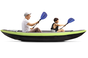 Boy and grandfather paddling in a canoe