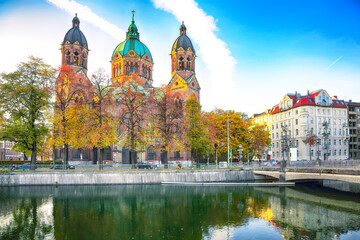 Fantastic autumn view on Saint Lucas Church (Lukas kirche), the largest Protestant church in Munich, and Isar River