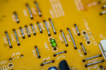 A microcircuit with transistors, resistors, capacitors, coils, contacts on an electronic board in...
