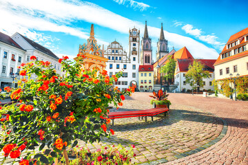 Splendid autumn cityscape of Oschatz central square with Stadtverwaltung and St. Aegidien church