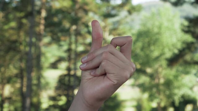 Beautiful hand of a young man snaps his fingers