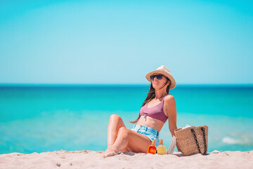 Young woman in hat on the beach vacation