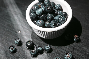 Berry background. Fresh berry blueberries on a black background. Concept of healthy and diet food....