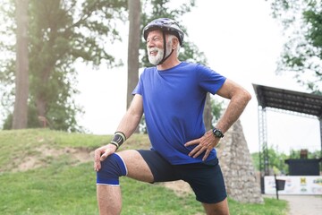 Senior sportsman doing stretching exercise at park