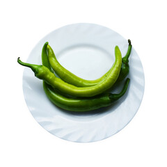 Three green hot peppers pods on a plate top view. Healthy spicy food on white background