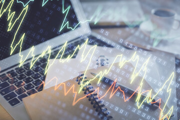 Double exposure of financial chart drawing and desktop with coffee and items on table background. Concept of forex market trading
