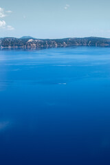 Crater Lake National Park Service boat crossing Crater Lake in Oregon.