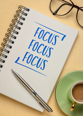 Focus concept - handwriting in a spiral notebook with a cup of espresso coffee, business, productivity and prioritizing