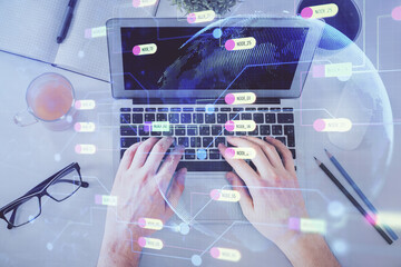 Multi exposure of man's hands typing over computer keyboard and data theme hologram drawing. Top view. Technology concept.