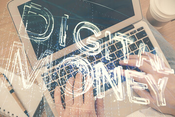 Double exposure of man's hands typing over computer keyboard and crypto currency theme hologram drawing. Top view. Blockchain concept.