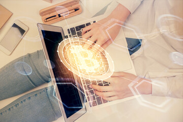 Fototapeta na wymiar Double exposure of woman hands working on computer and blockchain theme hologram drawing. Top View. bitcoin cryptocurrency concept.