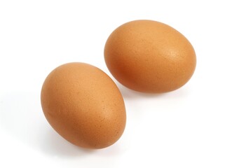 CHICKEN EGGS AGAINST WHITE BACKGROUND