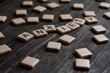 Anxiety Text. Flat lay photography - Word/s made with lettered tiles on timber background.