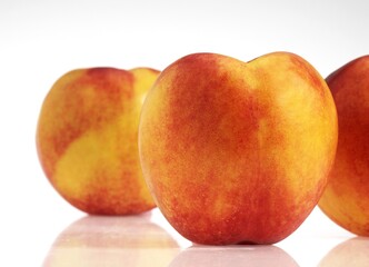 NECTARINE FRUITS AGAINST WHITE BACKGROUND