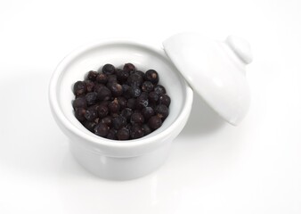JUNIPER BERRIES AGAINST WHITE BACKGROUND
