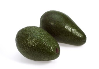 AVOCADOS AGAINST WHITE BACKGROUND
