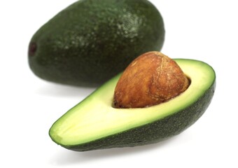 AVOCADO AGAINST WHITE BACKGROUND