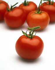 RED TOMATOES AGAINST WHITE BACKGROUND