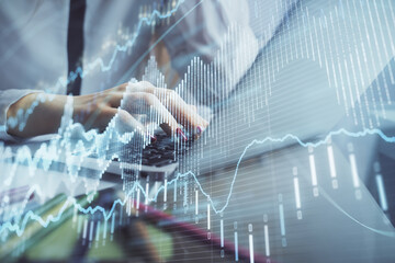 Double exposure of woman hands typing on computer and financial graph hologram drawing. Stock market analysis concept.